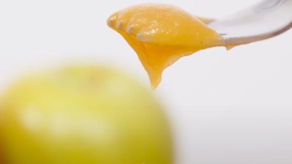 Pureed apple with apples in background